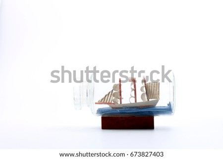 small ship in a bottle on a white background.