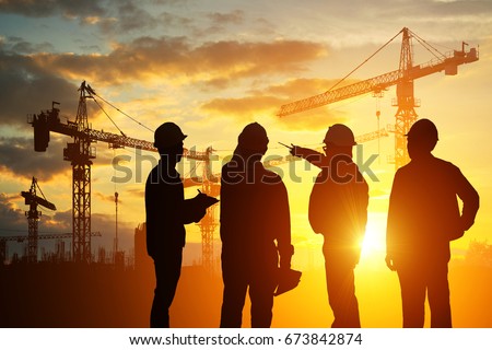 Silhouette Teams engineer looking construction worker in a building site at sunset Royalty-Free Stock Photo #673842874