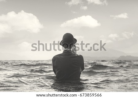 surreal black and white man thinking underwater