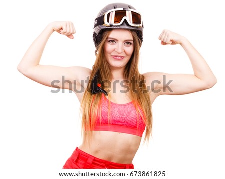 Winter sport people concept. Strong woman with sporty helmet. Young lady wearing red clothing. 