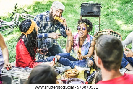 Group of happy friends joking and having fun at barbecue picnic outdoor - Young diverse culture students enjoying dinner in nature park - Youth, summer ,friendship concept - Focus on afro girl