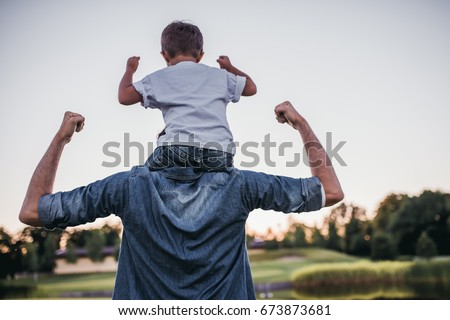 Dad and son having fun outdoors. Royalty-Free Stock Photo #673873681