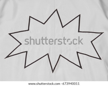 White denim background with cartoon balloon boom embroidery with empty space