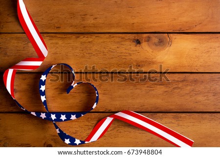 The American flag pattern and heart-shaped ribbon on wooden table/Independence Day,Memorial Day
