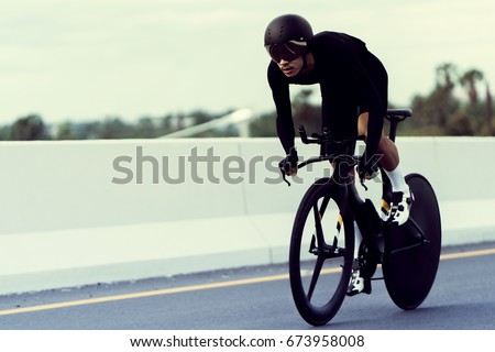 Asian men are cycling "time trial bike" in the morning Royalty-Free Stock Photo #673958008