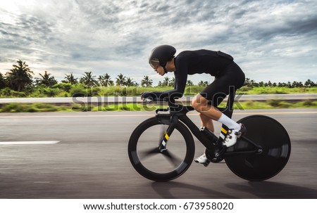 Asian men are cycling "time trial bike" in the morning Royalty-Free Stock Photo #673958020