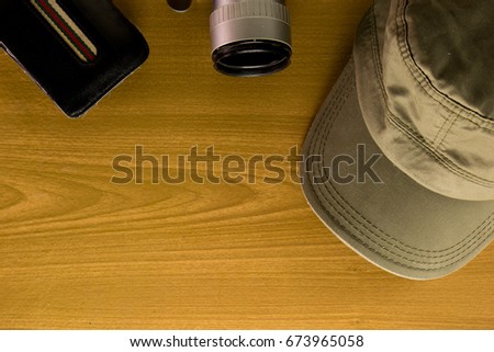 The travel accessories include  money pocket camera  cap key  notebook on the wood background and copy space ,The  traveler concept , The  equipment for go outside and vacation items