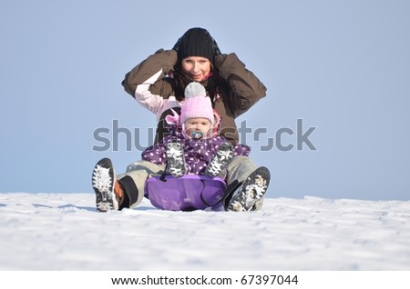Baby and mother in cold winter day