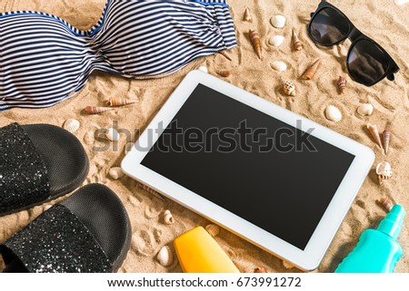 Summer bikini and accessories stylish beach set, Beach bikini summer outfit and sea sand as background, Top View, Concept