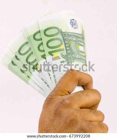 Hand holding money, Euro money.
