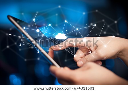 Female hands touching tablet with white cloud concept Royalty-Free Stock Photo #674011501