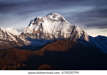 Panorama of mount Dhaulagiri - view from Poon Hill on Annapurna Circuit Trek in the Nepal Himalaya. Dhaulagiri I is the seventh highest mountain in the world at 8167 metres (26,795 ft) above sea level Royalty-Free Stock Photo #674030794
