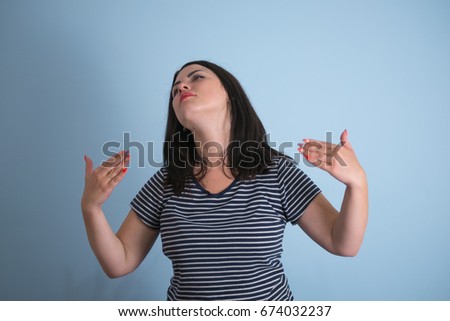 Closeup portrait young funny looking woman opening shirt to vent, blow air, it's hot unpleasant awkward situation, embarrassment. Isolated white background. Negative emotion, facial expression feeling