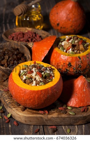 rice with dried fruit in a pumpkin, vertical, closeup