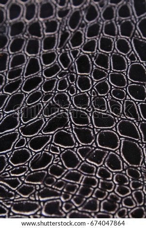 Snake skin faux fashion fabric. Close up snake leather texture.