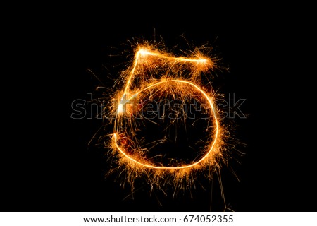 5 5th  five number from sparkler on black background.
