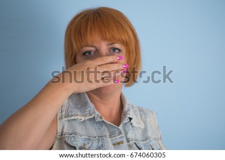 woman with hand over her mouth