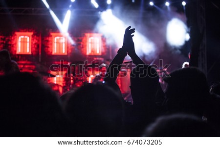 Cheering crowd at concert, night entertainment, music festival, happy youth, luxury party