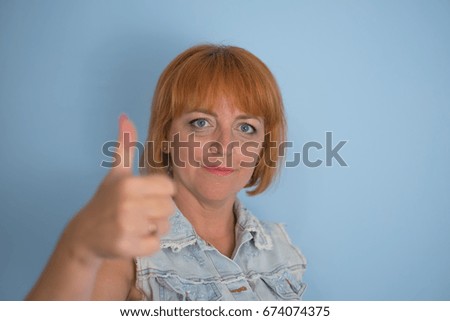 Girl showing thumb up, OK