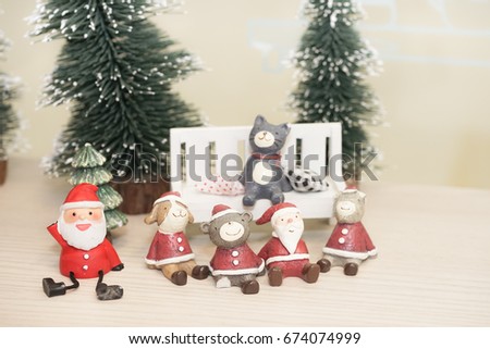 Christmas dolls. Dog, bear, cat and old men in the red suites sit and smile in the Christ mas time. 