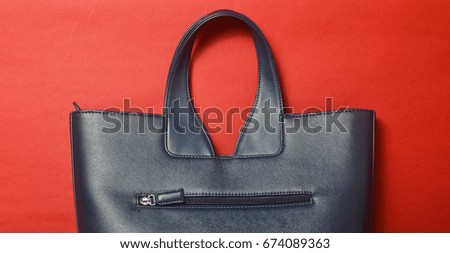 Handle of a female bag on a red background. Top view.