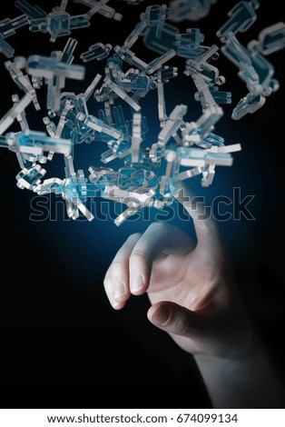 Businessman on blurred background holding 3D rendering group of blue people