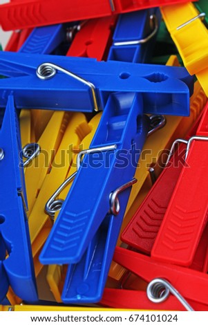 Colorful forecaps tweezers clips as background.Blue yellow green red clips forecaps as backdrop.