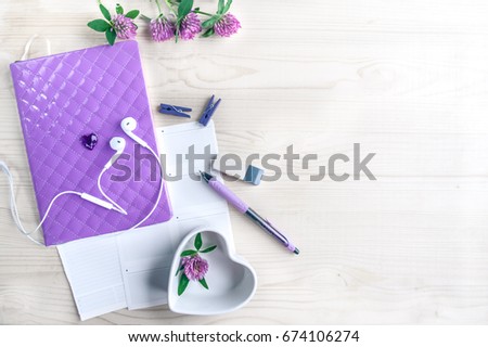 Mockup for the girl, women, a set of objects in lilac, tones. Diary, pen, headphones, saucer-heart, flowers clover. Dreams of a girl in love. Diary of love. Dreams of a new life.  space for text
