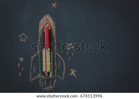 Top view Back to school or business start up background.The rocket create by pencil and drawing by chalk board with around star  on blackboard.copy space.above view.flat lay.