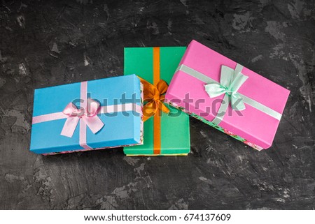 Gift boxes on concrete gray dark background