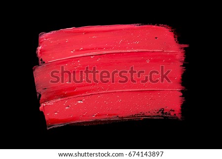 Coral red smudged lipstick black isolated background
