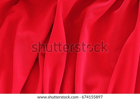 Silk dress material cloth texture pattern. 
tailoring stitching concept. Shiny beautiful fashion fabric. Shiny clothing material sample.Creased fabric. Red.