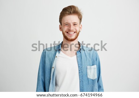 Portrait of young handsome hipster man with beard smiling laughing looking at camera over white background. Royalty-Free Stock Photo #674194966