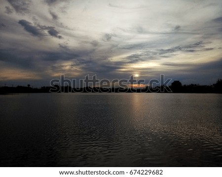 Evening sky There is sunlight on the water. Lake in the park. sunset reflection. cloud before raining. skyline are beautiful.