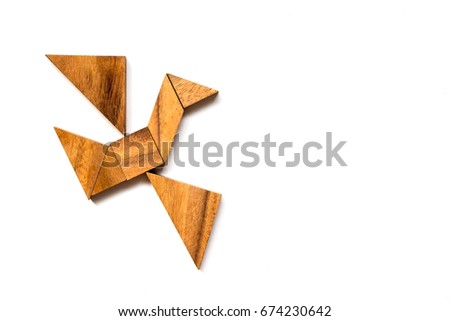 Wooden tangram puzzle in flying bird shape on white background (Concept of business start up or entrepreneur)