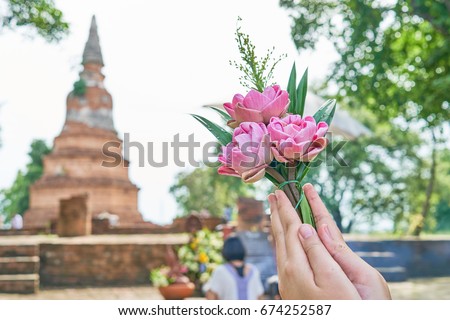 Close up Hand of woman that pay homage to Buddha image. This activity is shown to believing in a Buddha religion of people.