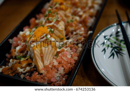 Japanese food Salmon roll Shusi on wooden table in living room.(Selective Focus)  