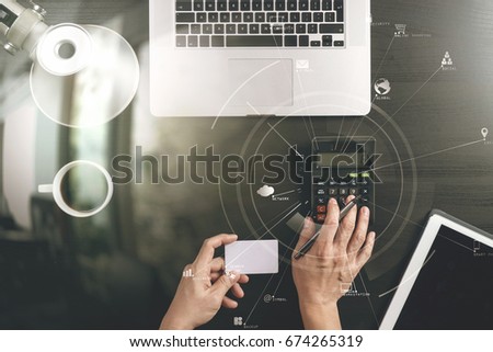 Internet shopping concept.Top view of hands working with calculator and laptop and credit card and tablet computer on dark wooden table background with Vr ,Social distancing and Working from home.