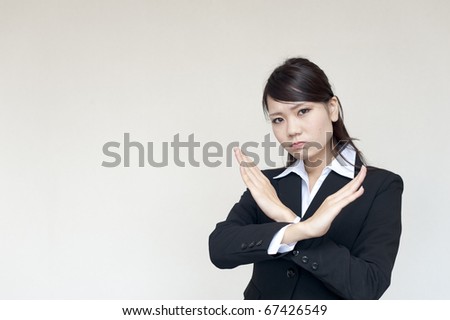 a portrait of young business woman showing x gesture isolated on white background