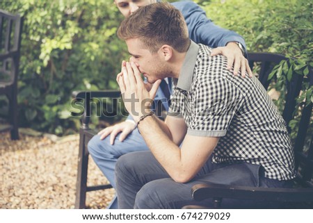 Guys Sharing Life Problems Always Support Best Friends. Friends Getting Down Heart Broken. Sad Man sitting outdoor in the park feeling sadness has a problems Life Crisis. Best Friend Mental Concept. Royalty-Free Stock Photo #674279029