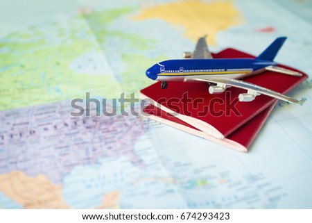 toy aircraft with two neutral passports on the map, travel concept, flight to america, trip by plane. pasport and plane on world map Royalty-Free Stock Photo #674293423