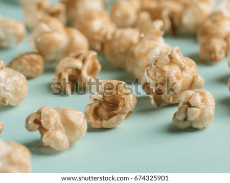 popcorn on blue background. Movie background with copy space. Vertical. Selective focus.