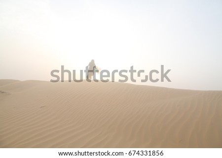 a arabic women in desert dune with balloon