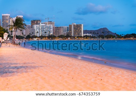 View of Waikiki beach with Diamond Head on the background at the sunset