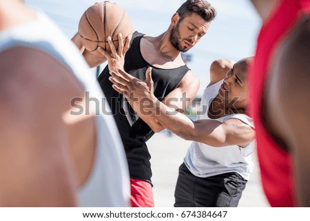 selective focus of multicultural basketball players during game on court