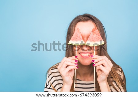 Summer, vacation, diet and vegans concept - Beautiful smiling funny young woman holding watermelon slice on stick