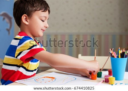 Boy, drawing a picture for father day.             