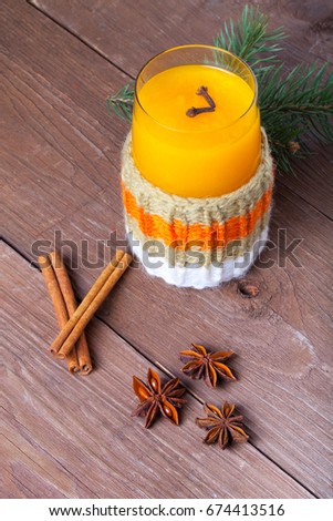 Glass of sea buckthorn beverage (kissel) on a brown wooden table or board for background. New year theme.