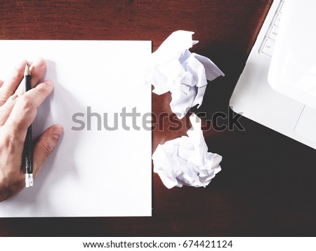 Businesses have both been successful and fail. The picture of paper, pencil, laptop, and men hand gesture above wooden table.  soft tone