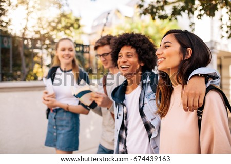 College students walking together outdoors. Group of young people in college campus. Royalty-Free Stock Photo #674439163